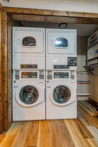 four washers and dryers are in a room at Pintler's Portal Hostel in Anaconda