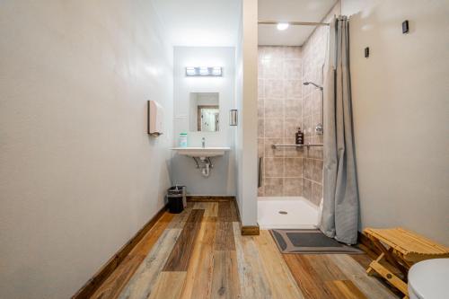 a bathroom with a shower and a sink at Pintler's Portal Hostel in Anaconda