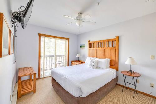 a bedroom with a white bed and a window at Snow Creek Lodge by FantasticStay in Fernie