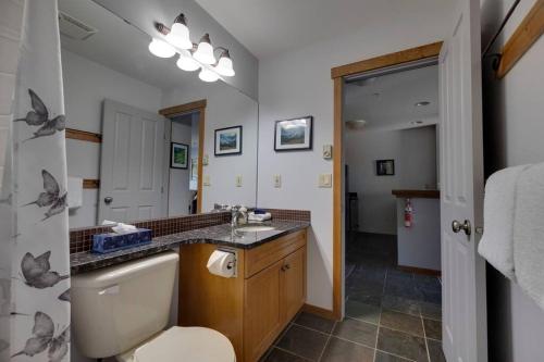 a bathroom with a sink and a toilet at Snow Creek Lodge by FantasticStay in Fernie
