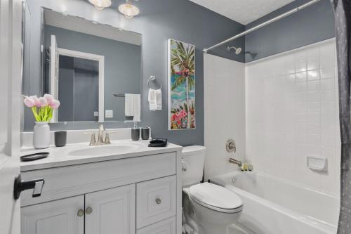 a bathroom with a sink and a toilet and a tub at Cozy 4BR Townhome, Family Community, 40 Mins to DC in Sterling