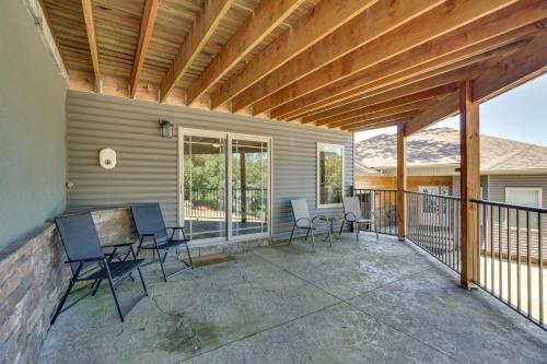 a patio with chairs and a table on a porch at Spacious Lake of the Ozarks Escape with Deck and Views in Linn Creek