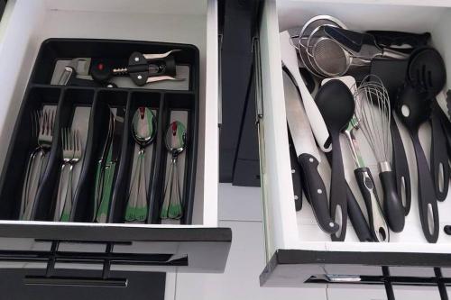 a drawer filled with utensils in a kitchen at Maggie's Inn in Soufrière