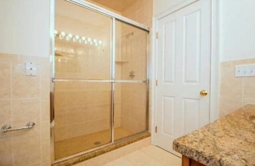 a shower with a glass door in a bathroom at The Luxe Loft 4BR Apartment in NYC! in New York