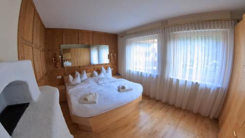 a bedroom with a large white bed and a window at Appartment Brüsl in Strass