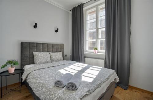 a bedroom with a bed with two towels on it at Warsaw Premium Apartments Deluxe Old Town in Warsaw