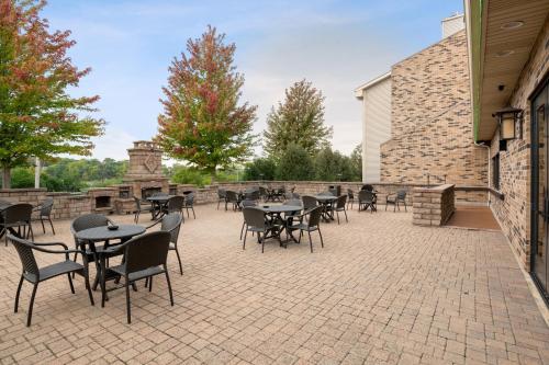a patio with tables and chairs on a brick patio at Antioch Hotel & Suites in Antioch