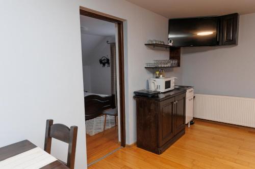 a kitchen with a microwave on top of a counter at Casa Iager - Vama Buzaului 