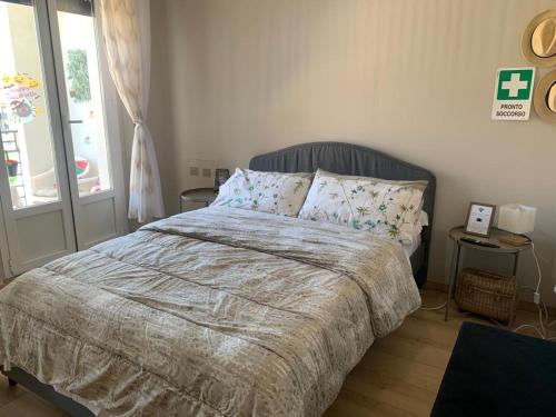 a bedroom with a bed and a window at Sweet home in Varese