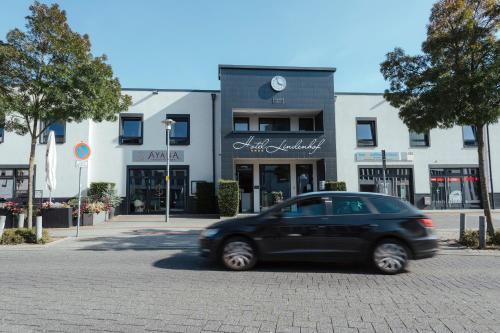 a black car parked in front of a building at Hotel Lindenhof in Erkelenz