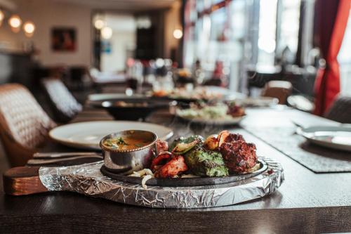 a table with plates of food on a table at Hotel Lindenhof in Erkelenz