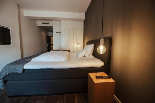 a bedroom with a bed and a table in it at Hotel Lindenhof in Erkelenz