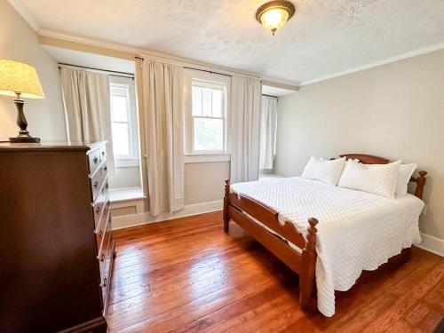 a bedroom with a bed and two windows at Spacious Craftsman near Staunton in Staunton