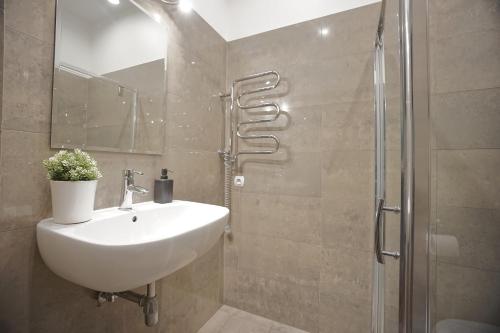 a bathroom with a sink and a shower at Warsaw Premium Apartments Standard Old Town in Warsaw