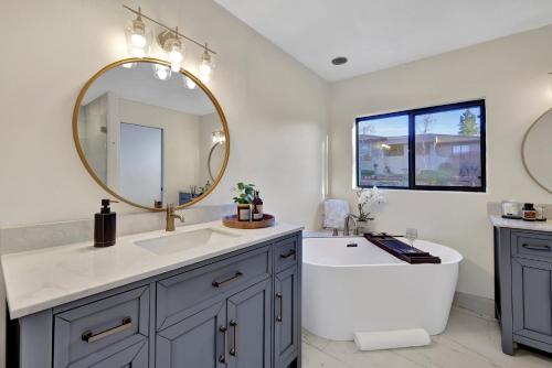 a bathroom with a tub and a sink and a mirror at Three Bedroom, Amazing Views, Hot Tub and Pets Allowed, Close to Chapel of the Holy Cross and Chapel Hill, less than 1mi to Trailheads in Sedona