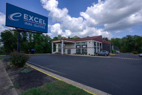 a sign in front of a inn suites at Excel Inn & Suites in Fredericksburg