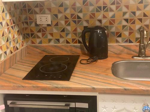 a kitchen counter with a stove and a sink at One Bedroom with Balcony WI-FI Downtown Sheraton Plaza 226 in Hurghada