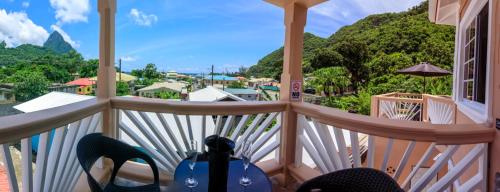 a balcony with a view of the mountains at Maggie's Inn in Soufrière