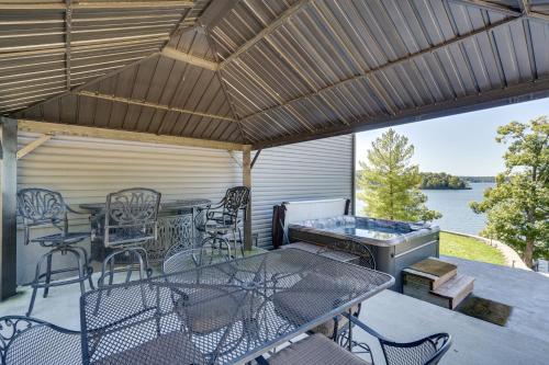 a patio with a table and chairs and a grill at Spacious Lake of the Ozarks Escape with Deck and Views in Linn Creek
