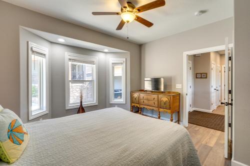 a bedroom with a bed and a ceiling fan at Spacious Lake of the Ozarks Escape with Deck and Views in Linn Creek
