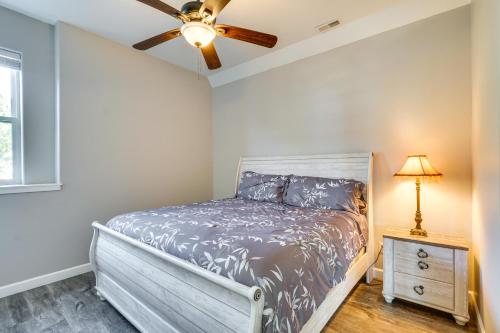 a bedroom with a bed and a ceiling fan at Spacious Lake of the Ozarks Escape with Deck and Views in Linn Creek