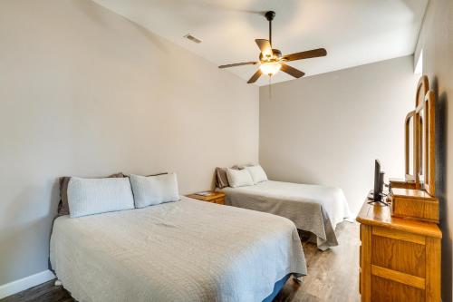 a bedroom with two beds and a ceiling fan at Spacious Lake of the Ozarks Escape with Deck and Views in Linn Creek