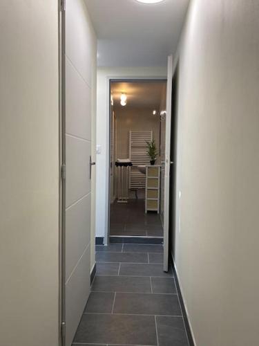 a hallway with a hallway leading to a dining room at Maison de Charme - 4 Chambres - Courette & Parking Gratuit in Amiens