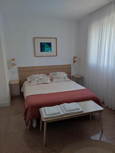 a bedroom with a large bed with two towels on it at Apartamento Albejo in Laredo