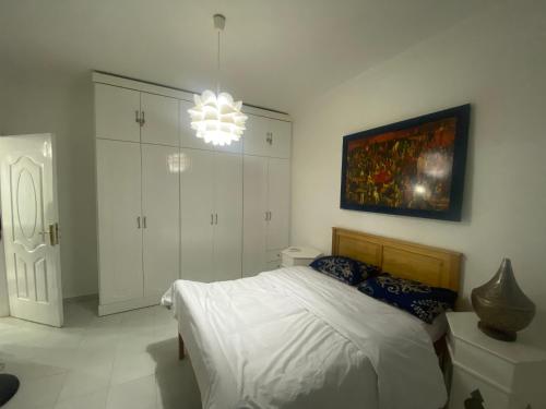 a bedroom with a bed and a painting on the wall at One Bedroom with Balcony WI-FI Downtown Sheraton Plaza 226 in Hurghada