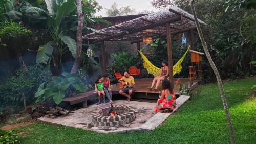 a group of people sitting around a fire pit at Pousada Casa Viva a Vida in Lençóis