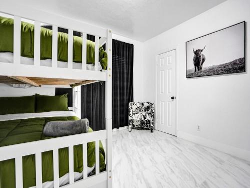 a bedroom with a bunk bed and a chair at Chic Miami Escape- 4 Bedrooms, Game Room, Fire Pit, Pergola in North Miami Beach