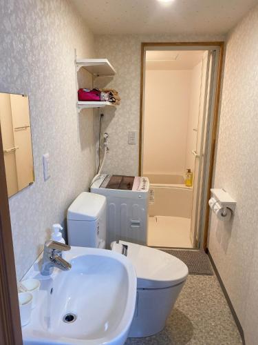 a bathroom with a white sink and a toilet at Kawaramachi Station · home - Vacation STAY 37891v in Takamatsu