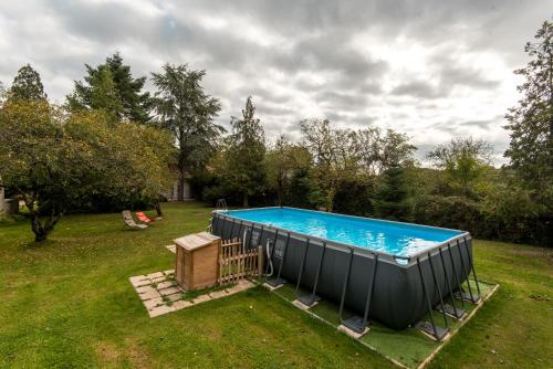 une grande piscine dans une cour dans l'établissement Le cèdre du Prieuré, à Montreuil-le-Henri