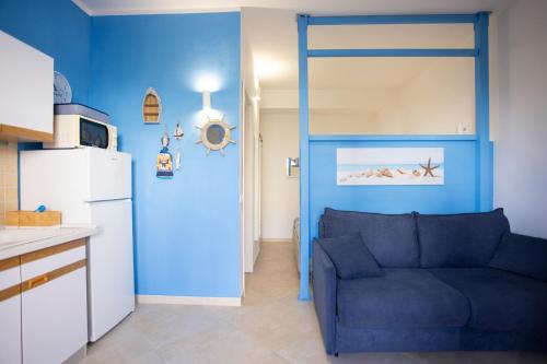 a blue living room with a couch and a refrigerator at Casa di Marta San Vito Lo Capo in San Vito lo Capo