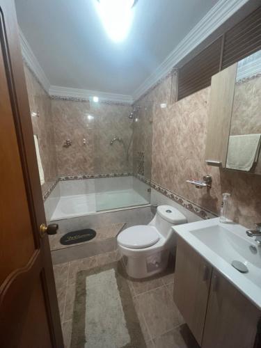 a bathroom with a tub and a toilet and a sink at Apartamento en el ingenio 2 in Cali