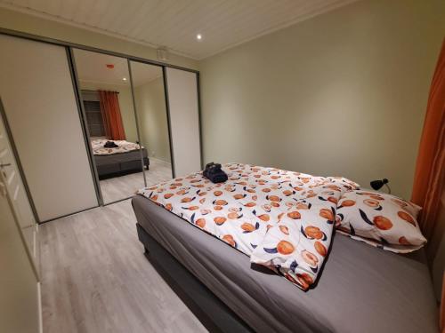 a bedroom with a bed and a large mirror at LENA - Brand new apartment - Modern & Cozy in Närpes - Built in 2023 in Närpiö