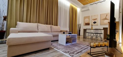 a living room with a couch and a table at LUXURY APARTMENT in Tirana