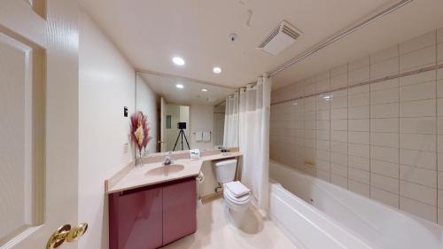 a bathroom with a sink and a toilet and a tub at Powderhorn by Whistler Premier in Whistler