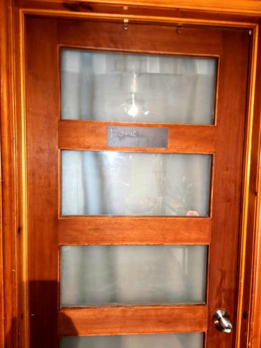 a wooden door with three glass windows on it at Gîte B&B - Aubergélit inc in Saint-Jean-Port-Joli