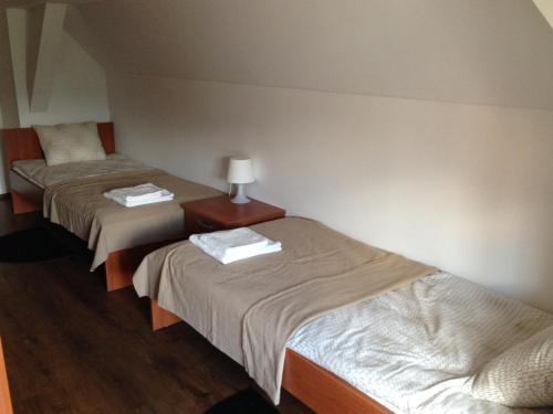 a room with two beds and a table with a lamp at B&B Rot in Bohinjska Bela