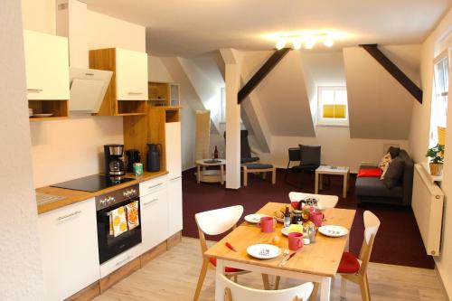 a kitchen and dining room with a table and a kitchen and a living room at Stadtwohnung in Calau (Spreewald) in Calau