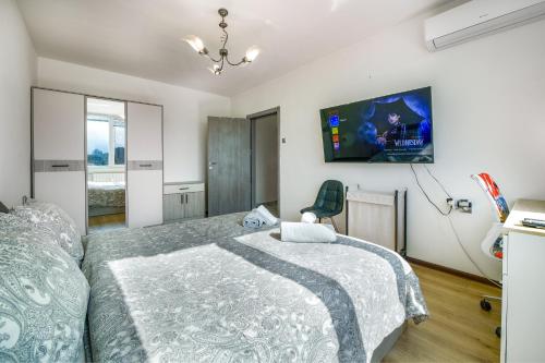 a bedroom with a bed and a tv on the wall at Nova #7 in Sofia