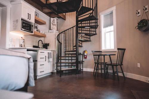 a kitchen with a spiral staircase and a table and chairs at Silo Suite 1 Pet Friendly- Near Zion National Park in La Verkin