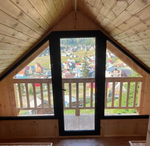 a room with a large window in a cabin at Chalet Bakhmaro in Chʼkhakoura