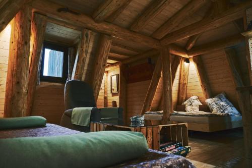 a room with a bed in a wooden cabin at Domček v pieninach . in Majere