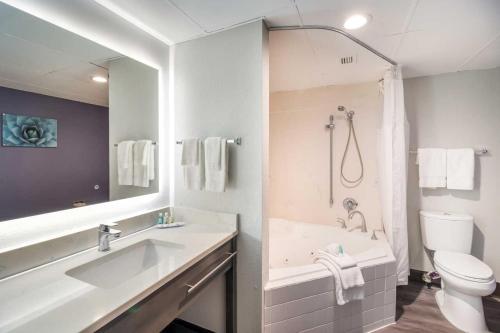 een badkamer met een bad, een toilet en een wastafel bij Quality Inn near MCAS Cherry Point in Havelock