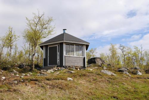 a small house on top of a hill at Haltinmaa Cottages in Kilpisjärvi