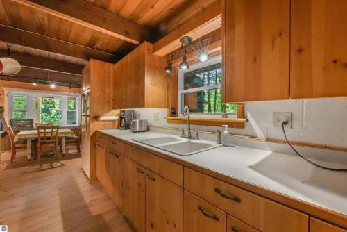 a kitchen with a sink and a counter top at Wildlife Haven Retreat in Evart