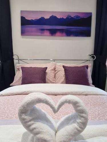 a bed with a heart shaped towel on it at Make yourself at home! Large Rooms, Comfy in Headingley