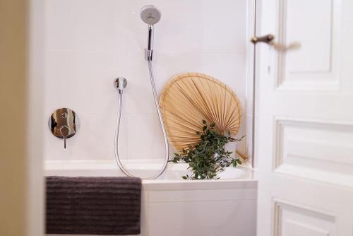 a bathroom with a shower and a plant on a sink at MyLivingOne I Friedrich I - Luxus-Apartment in Mannheim